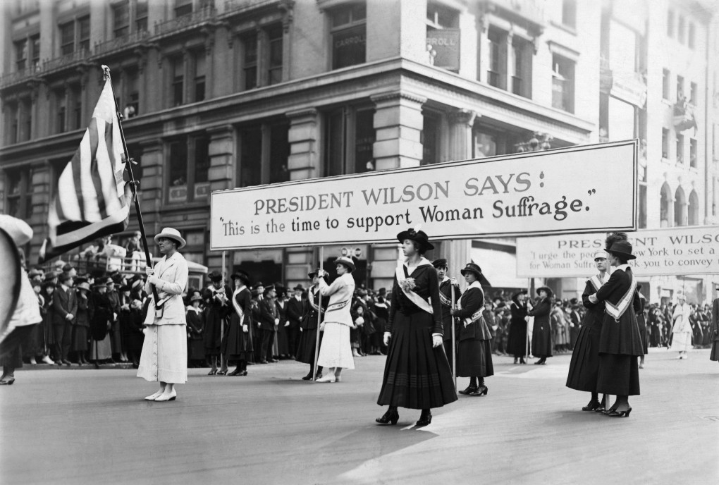 1916, Probably New York, New York, USA --- Women suffrage parade backing Woodrow Wilson's campaign for Woman's votes, 1916. Mrs. Chas, Tiffany with flag. Photograph. --- Image by © Bettmann/CORBIS